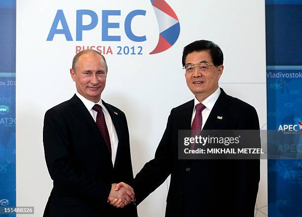 Russian President Vladimir Putin welcomes Chinese President Hu Jintao during the Asia-Pacific Economic Cooperation Summit in Russia's far eastern...
