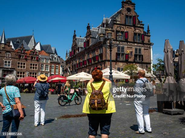 Tourists are seen taking photos in the city center, during the warmest day in The Netherlands, on July 8th, 0223.