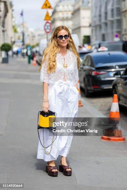 Blanca Miro Scrimieri is seen wearing white laced top, skirt, black yellow bag outside Chanel during the Haute Couture Fall/Winter 2023/2024 as part...