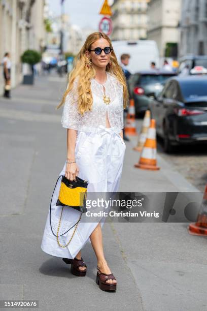 Blanca Miro Scrimieri is seen wearing white laced top, skirt, black yellow bag outside Chanel during the Haute Couture Fall/Winter 2023/2024 as part...