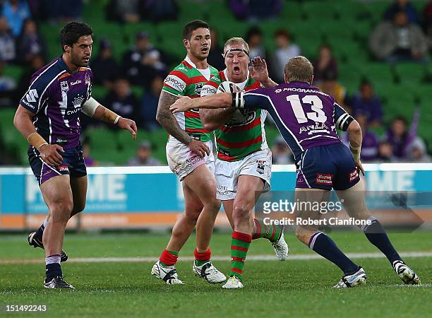 Michael Crocker of the Rabbitohs is challenged by his opponents during the Second NRL Qualifying Final match between the Melbourne Storm and the...