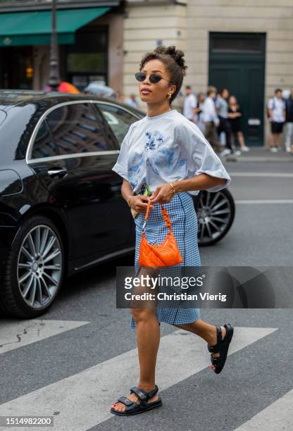 Ellie Delphine is seen wearing white shirt, orange bag, blue checkered skirt with slit outside Stéphane Rolland during the Haute Couture Fall/Winter...