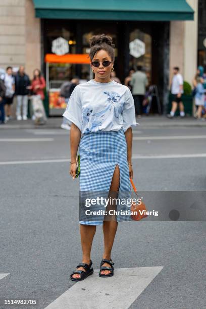 Ellie Delphine is seen wearing white shirt, orange bag, blue checkered skirt with slit outside Stéphane Rolland during the Haute Couture Fall/Winter...