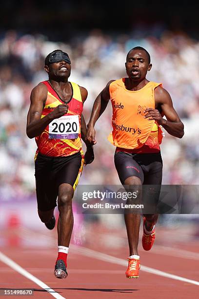 Jose Sayovo Armando of Angola and his guide compete in the Men's 100m T11 semifinals on day 10 of the London 2012 Paralympic Games at Olympic Stadium...