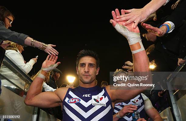 Matthew Pavlich of the Dockers high fives fans as he leaves the ground after winning the Second AFL Elimination Final match between the Geelong Cats...