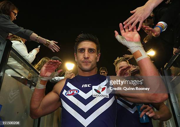 Matthew Pavlich of the Dockers high fives fans as he leaves the ground after winning the Second AFL Elimination Final match between the Geelong Cats...