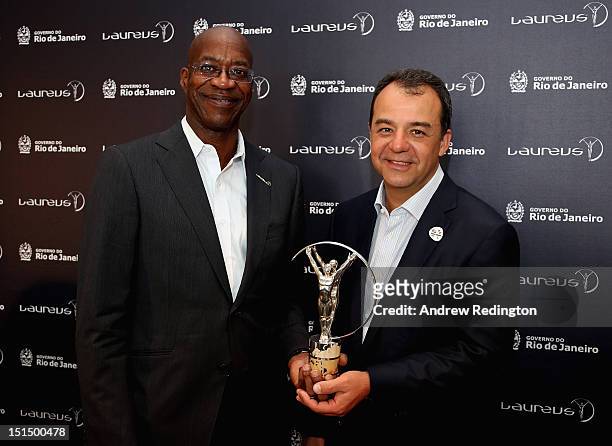 Edwin Moses, Chairman of Laureus, and Sérgio Cabral, Governor of the State of Rio de Janeiro, pose with a Laureus statuette following the press...