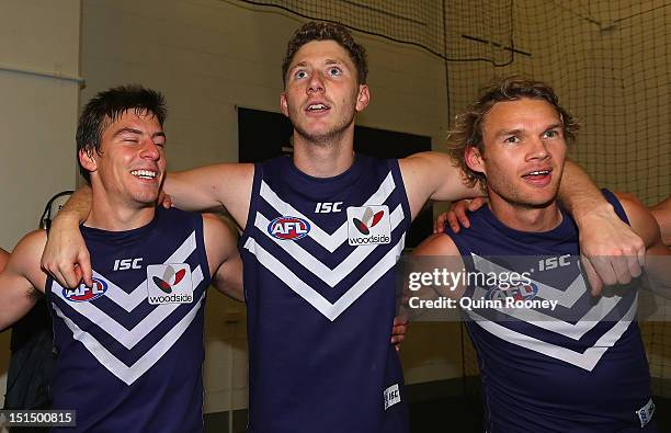 Nick Suban, Zac Dawson and Paul Duffield of the Dockers sing the song in the rooms after winning the Second AFL Elimination Final match between the...