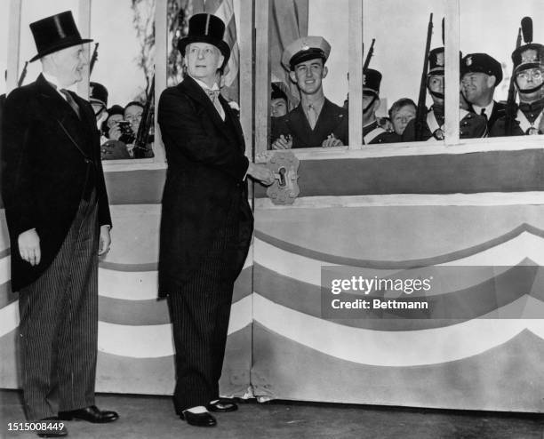 Governor Olson unlocks the Golden Gate beside Leland Cutler - President of the Expo, to the San Francisco Exposition, California, United States, 20th...