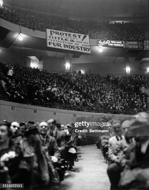 More than 25,000 persons packed Madison Square Garden in a huge demonstration against reported persecutions of German Jews by the Hitler government,...