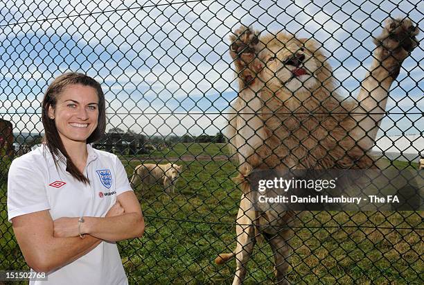 Karen Carney of England women's national football team poses with some white lions during a player appearance at West Midlands Safari Park on...