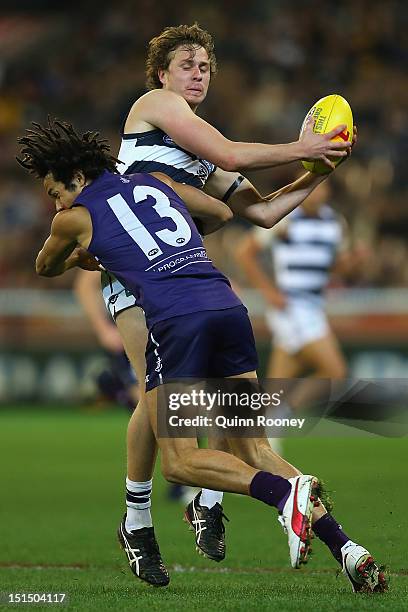 Mitch Duncan of the Cats is tackled by Tendai Mzungu of the Dockers during the Second AFL Elimination Final match between the Geelong Cats and the...