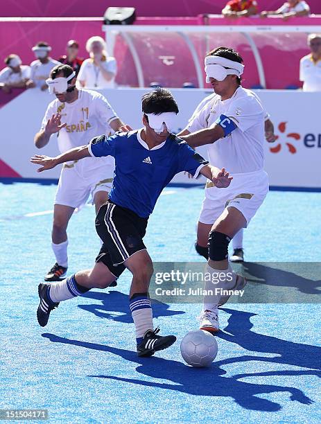 Lucas Rodriguez of Argentina goes past Adolfo Acosta Rodriguez of Spain in the bronze medal match during the 5 a-side Football on day 10 of the...