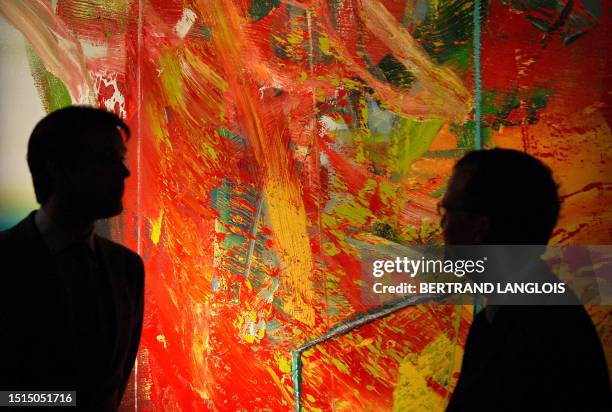 Sothebys auction house employees prepare to exhibit a painting by German artist Gerhard Richter entitled 'Stuhl ' during a photocall at the auction...