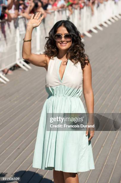 Salma Hayek poses next to the beach closet dedicated to her on the Promenade des Planches for the movie "Savages" during the 38th Deauville American...