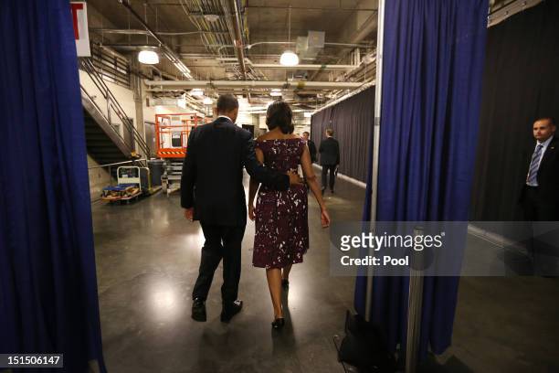 President Barack Obama and First Lady Michelle Obama walk to their car following President Obama's speech at the Democratic National Convention at...