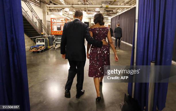President Barack Obama and First Lady Michelle Obama walk to their car following President Obama's speech at the Democratic National Convention in...