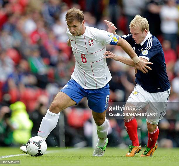 Scotland's Steven Naismith vies with Serbia's Branislav Ivanovic in a FIFA 2014 World Cup, group A, qualifying football match at Hampden Park,...