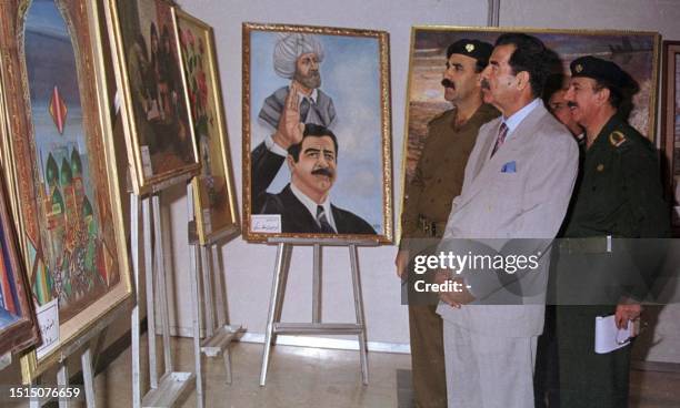 In this picture released 05 May 2000 by the Iraqi News Agency Iraqi President Saddam Hussein inspects gifts he received for his 63rd birthday, which...