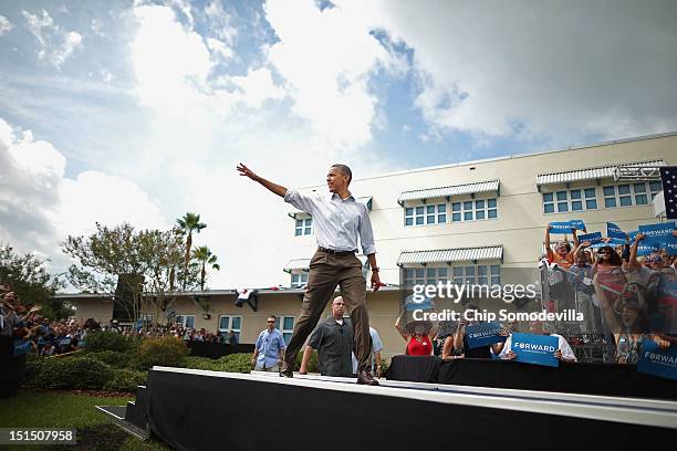 President Barack Obama waves to supporters as he takes the stage during a campaign on the campus of St. Petersburg College September 8, 2012 in St...