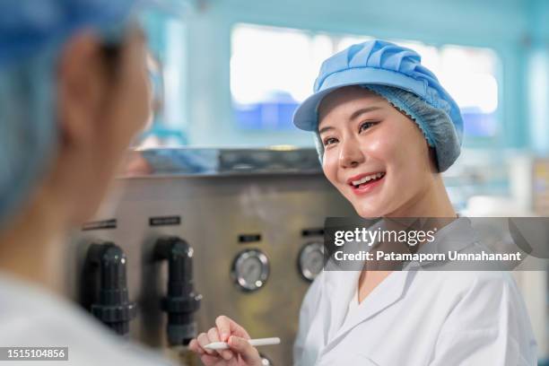 embrace the industrial revolution of the digital age. technician worker in the lab coat standing at water filter cabinet using digital tablet for control system and communicate seamlessly with machines. - modern industrial revolution stock pictures, royalty-free photos & images