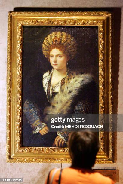 Picture taken 11 September 2006 at the Luxembourg museum in Paris shows a visitor looking at "Portrait d'Isabella d'Este" by Venice-born Tiziano...