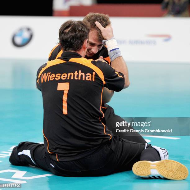 Heiko Wiesenthal of Germany and teammate Torben Schiewe celebrate after winning the bronze in the Men's Sitting Volleyball competition on day 10 of...