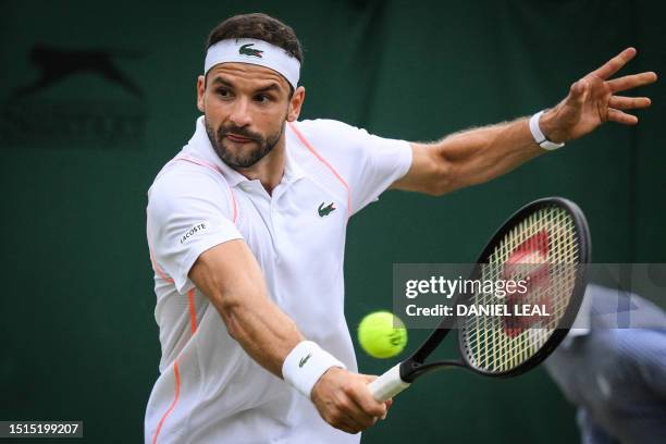 Bulgaria's Grigor Dimitrov returns the ball to US player Frances Tiafoe during their women's singles tennis match on the sixth day of the 2023...