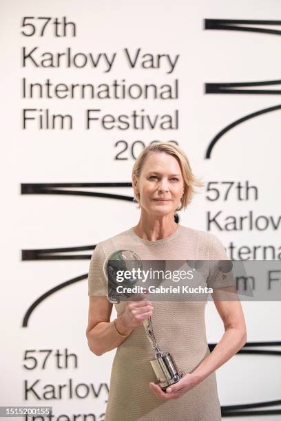 Robin Wright poses for a photo after she recieved the Crystal Globe for the Festival President's Award from the President of the festival Jiri...