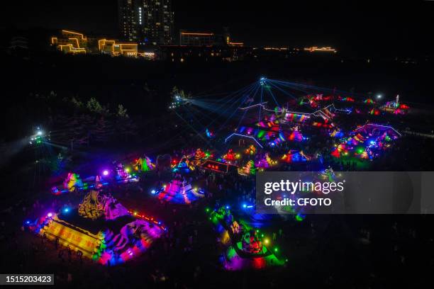 Tourists take part in the International Sand Sculpture Festival in Zhoushan City, Zhejiang Province, China, July 8, 2023.