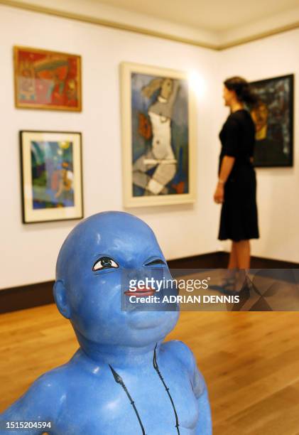 Chrisitie's employee looks at works of art at Christie's auction house, in London, on June 6, 2008. Christie's are holding a June auction of South...