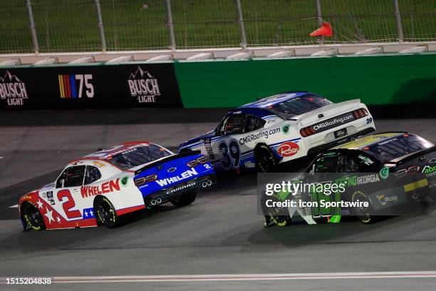 Sheldon Creed , Ryan Sieg and Chandler Smith race off into Turn 1 during the NASCAR Xfinity Series Alsco Uniforms 250 race on July 08, 2023 at the...