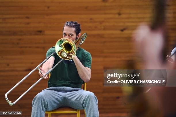 An inmate plays a trombone as he performs with professional musicians during a jazz concert held at Saint-Quentin-Fallavier prison in...