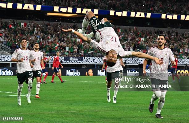 Mexico's midfielder Orbelin Pineda does a flip as he celebrates scoring his team's first goal on a penalty kick during the Concacaf 2023 Gold Cup...