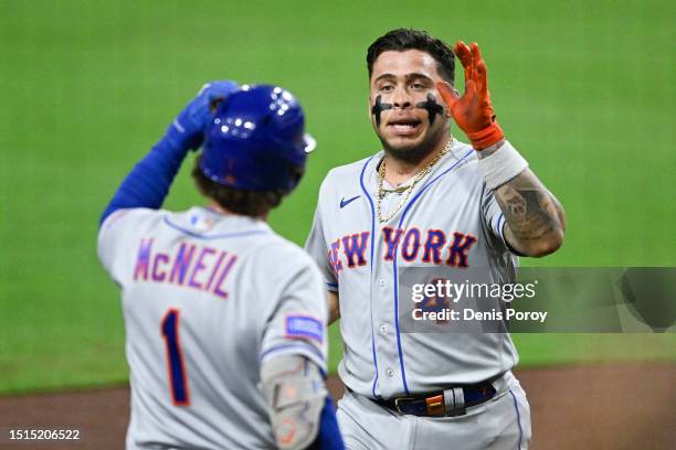 Francisco Alvarez of the New York Mets is congratulated by Jeff McNeil after hitting a solo home run during the sixth inning of a baseball game...