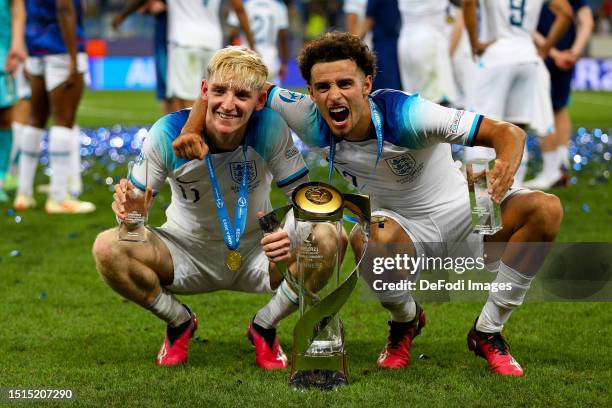 Anthony Gordon of England and Curtis Jones of England celebrate with the trophy after winning the UEFA Under-21 Euro 2023 final match between England...