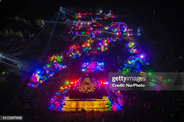 Tourists are taking part in the International Sand Sculpture Festival in Zhoushan City, Zhejiang Province, China, on July 8, 2023.