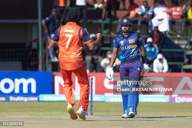 Netherlands' bowler Vikramjit Singh celebrates the wicket of Sri Lanka's Sadeera Samarawickrama plays a shot during the ICC Men's Cricket World Cup...