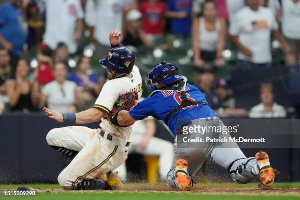 Miguel Amaya of the Chicago Cubs tags out Owen Miller of the Milwaukee Brewers at home plate in the 11th inning at American Family Field on July 04,...