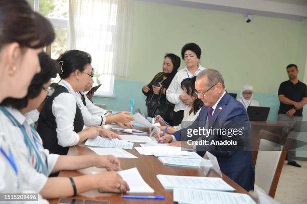 Ulughbek Inoyatov member of the People's Democratic Party casts his vote at a polling station during the early presidential election in Tashkent,...