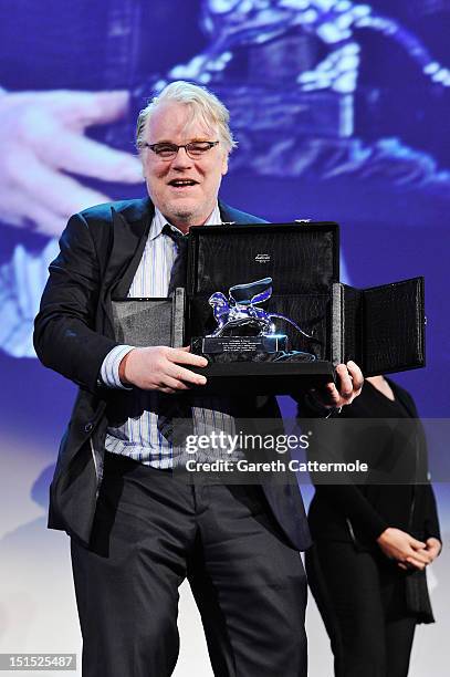 Actor Philip Seymour Hoffman collects the Silver Lion for Best Director on behalf of director Paul Thomas Anderson on stage during the Award Ceremony...