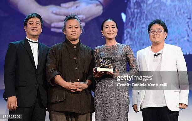 Director Kim Ki-Duk and Cho Min-soo pose with the Golden Lion award for best film during the Award Ceremony Inside during The 69th Venice Film...