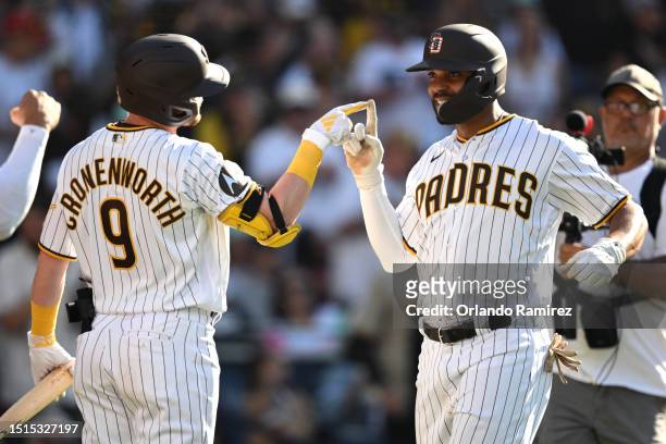 Xander Bogaerts of the San Diego Padres celebrates with Jake Cronenworth after hitting a two-run home run during the sixth inning against the Los...