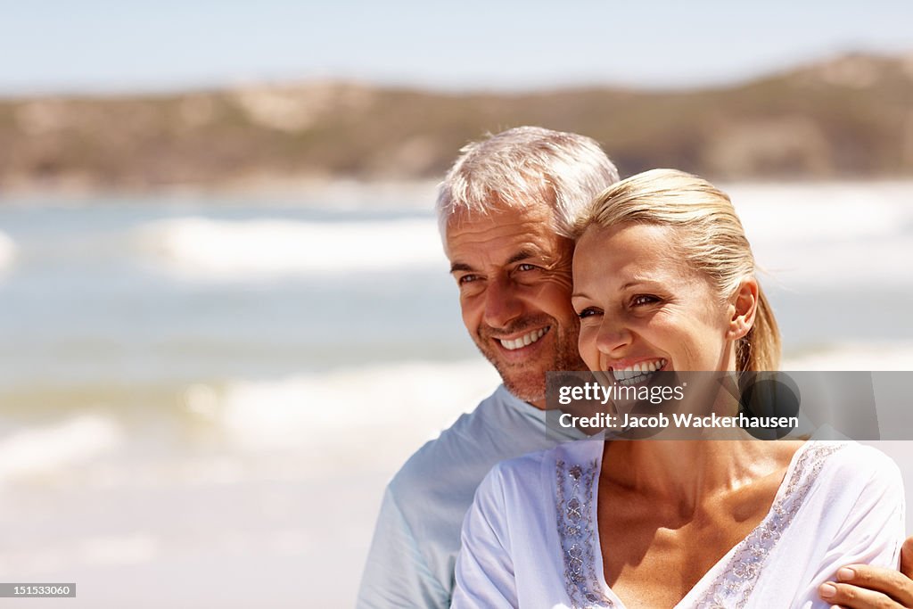 Happy mature couple enjoying at beach