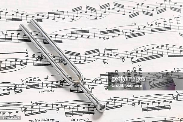 a-440 tuning fork and sheet music - tuning stock pictures, royalty-free photos & images