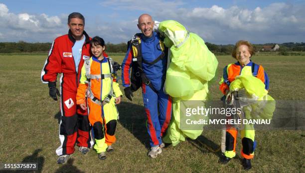 Ninety-five year old, French woman Blanche Olive and ten year old Pakistani-French teenager Oceane Malvy , pose with French paraglider pilots Mario...