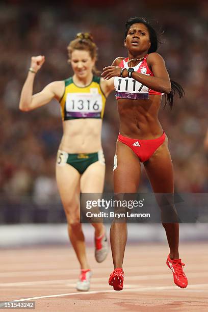 Yunidis Castillo of Cuba crosses the line to win gold ahead of silver medallist Anrune Liebenberg of South Africa in the Women's 400m T46 Final on...