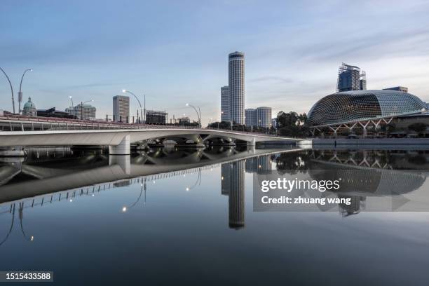 quiet water surface against singapore city - theme park singapore stock pictures, royalty-free photos & images