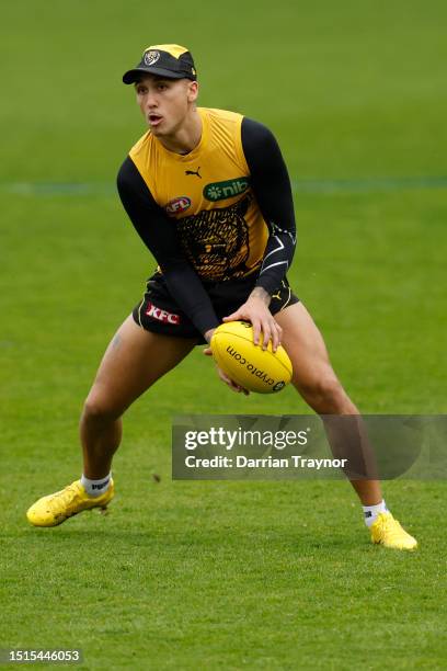 Shai Bolton of the Tigers handballs during a Richmond Tigers AFL training session at Punt Road Oval on July 05, 2023 in Melbourne, Australia.