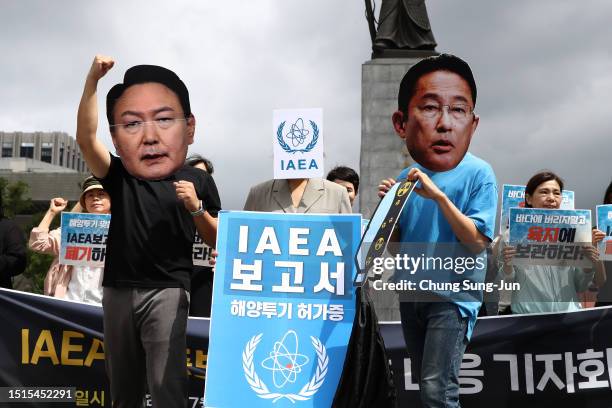 South Korean protesters wearing masks of Japanese Prime Minister Kishida and South Korea’s President Yoon Suk-Yeol during a protest against the...